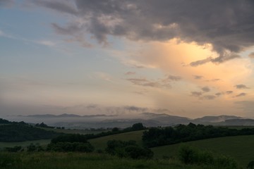 Naklejka na ściany i meble Sunrise and sunset over the hills and town. Slovakia