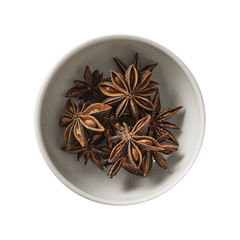 Star anise in bowl. Preparing ingredients for cooking. Isolated on white background. Top view.