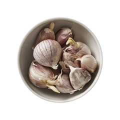 Garlic in wood spoon. Preparing ingredients for cooking. Isolated on white background. Top view.