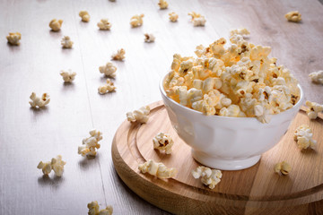 Salt popcorn on the wooden table, selective focus