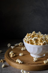 Air salty popcorn.A bowl of popcorn on a wooden table. Rustic style.