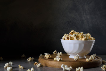 Air salty popcorn.A bowl of popcorn on a wooden table. Rustic style.