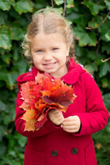 Smiling and rejoicing funny autumn kid.