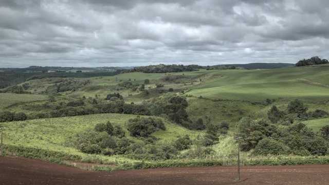 Timelapse of clouds passing by a rural landscape with a dirt road.  Frei Rog&eacute;rio, Santa Catarina / Brazil