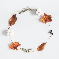 Autumn composition. Wreath made of eucalyptus branches, cotton flowers, dried leaves on pastel gray background. Autumn, fall concept. Flat lay, top view, copy space, square