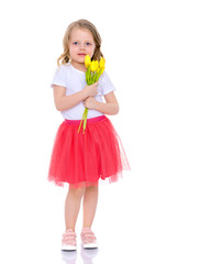 Little girl with a bouquet of tulips.