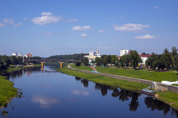 Fototapeta na wymiar Urban landscape. The blue sky is reflected in the river.