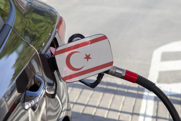 Fueling car with petrol pump at a gas station.