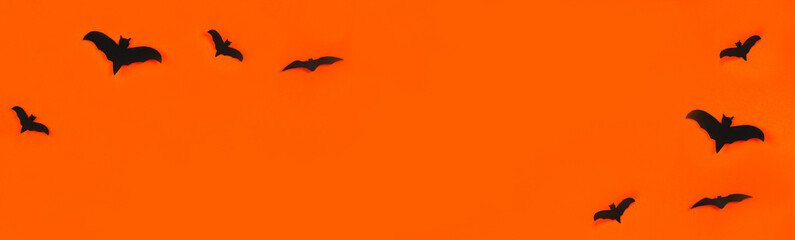 The concept for Halloween. Bats on an orange background. Copy space.