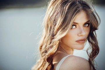 beautiful boho girl portrait with amazing eyes and lips standing near lake. attractive young woman...