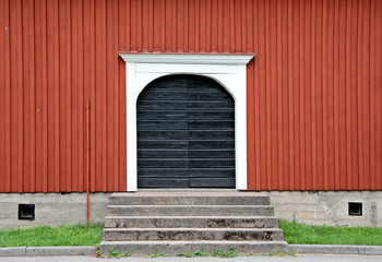 Black door on a red wall