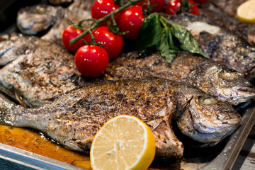 grilled fish with lemon and tomatoes Greek cuisine