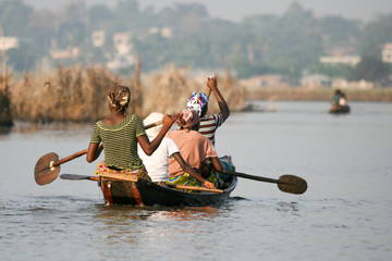 African women rowing on Lake Nokoue, Benin - obrazy, fototapety, plakaty