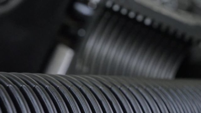 Manufacture of plastic water pipes. Manufacturing of tubes to the factory. The process of making plastic pipes on the machine tool with the use of water and air pressure. Special corrugated forms of