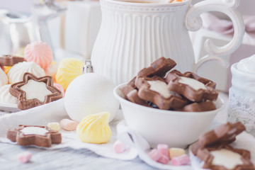 Cup of cacao with marshmallow, cookies, meringues and different Christmas decorations