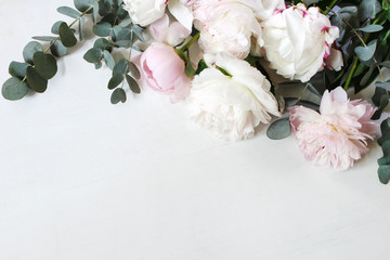 Styled stock photo. Decorative still life floral composition. Wedding or birthday bouquet of pink and white peony flowers and eucalyptus branches. White table background. Flat lay, top view. - obrazy, fototapety, plakaty
