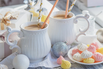 Cup of cacao with marshmallow, meringues and different Christmas decorations