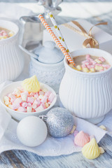 Cup of cacao with marshmallow, meringues and different Christmas decorations