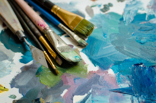 Artist paint brushes on the wooden palette
