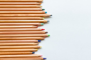 Obraz premium Wooden color pencils on white paper