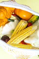 zero waste shopping. cotton bag full of vegatables on yellow background