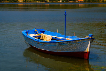 Naklejka premium A small fishing boat, floating on the sea... somewhere in Greece
