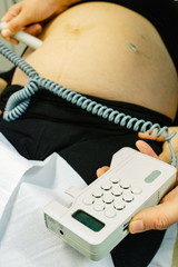 pregnant woman checked by midwife 