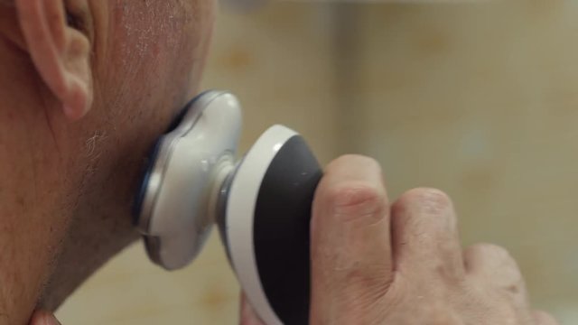 Man Shaving With Electric Shaver