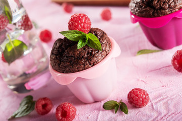 Sweet chocolate cupcake on pink background