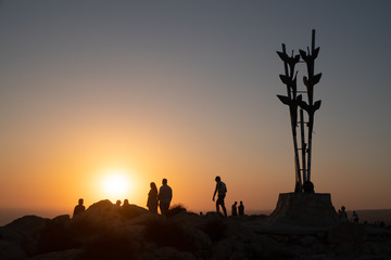 Fototapeta na wymiar People enjoying their walk of Cape Greco cliff during the sunset 