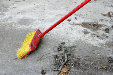 Image of red brush cleaning at garbage