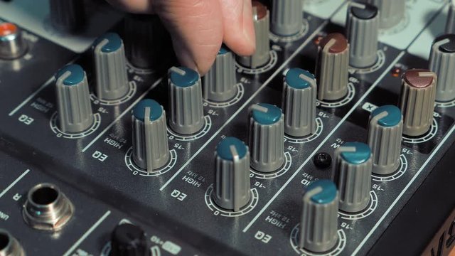 Man Adjusts To The Control Panel Of The Sound Music Mixer