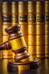 Law and justice concept - row of books with law gawel close up, retro toned