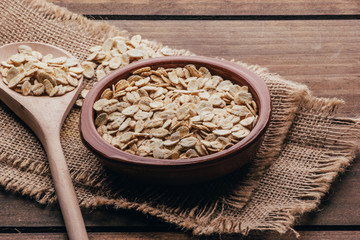 Container filled with uncooked oats, rustic style
