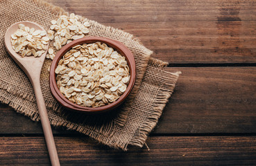 Container filled with uncooked oats, rustic style