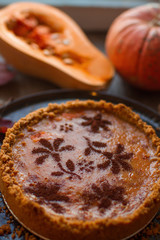 Tasty festive homemade pumpkin pie on rustic wooden table, traditional autumn food, healthy lifestyle, selective focus