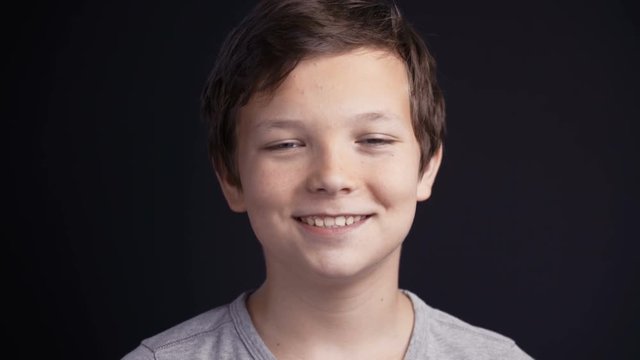 Portrait of boy looking the camera and laughing.