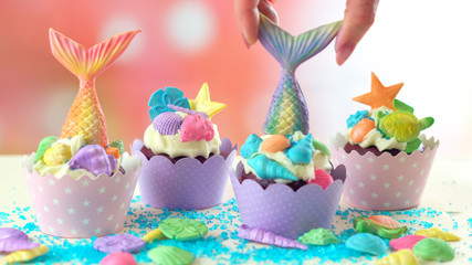 Mermaid theme cupcakes with colorful glitter tails, shells and sea creatures toppers for children's, teen's, novelty birthday and party celebrations.