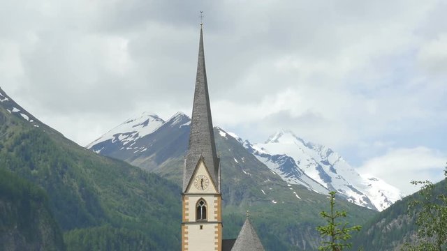 Zooming out view of the chapel in Heiligenblut am Grossglockner in Carinthia, Austria, with Grossglockner in the background.