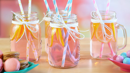 Pink lemonade in mason jars closeup on party table.