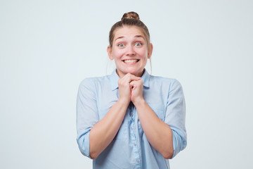 Portrait of pretty woman with shocked face. She is smiling broadly and can not believe in her luck.