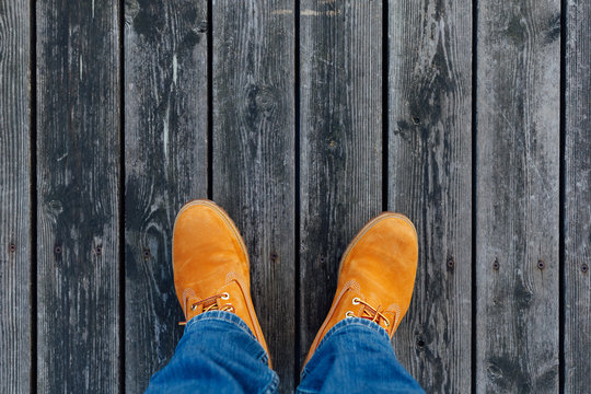 yellow winter boots on wooden planks background