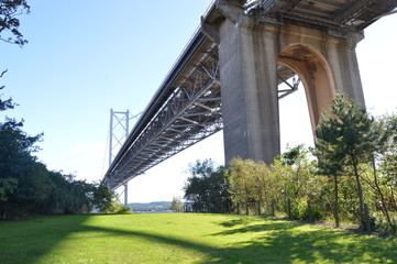 The original Forth Road Bridge crossing the River Forth, seen from beneath at North Queensferry, Fife, summer 2018