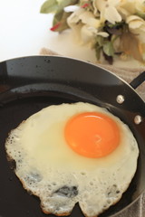 Sunny fried egg on frying pan