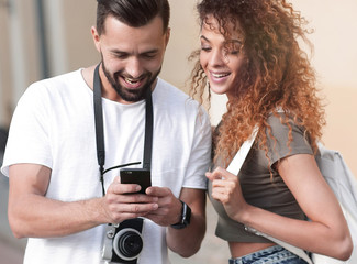 Young couple visiting city in summertime and looking photos