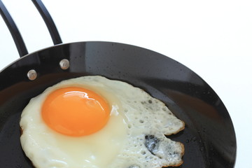 Sunny fried egg on frying pan