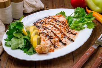 salmon in a creamy caviar sauce