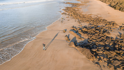 Aerial View of Waves and People and Beach Along Great Ocean Road, Victoria, Australia at Sunrise