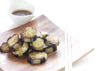 Asian food, pan fried eggplant on wooden plate