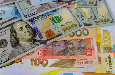 us dollars and Ukrainian hryvnia background different banknotes of